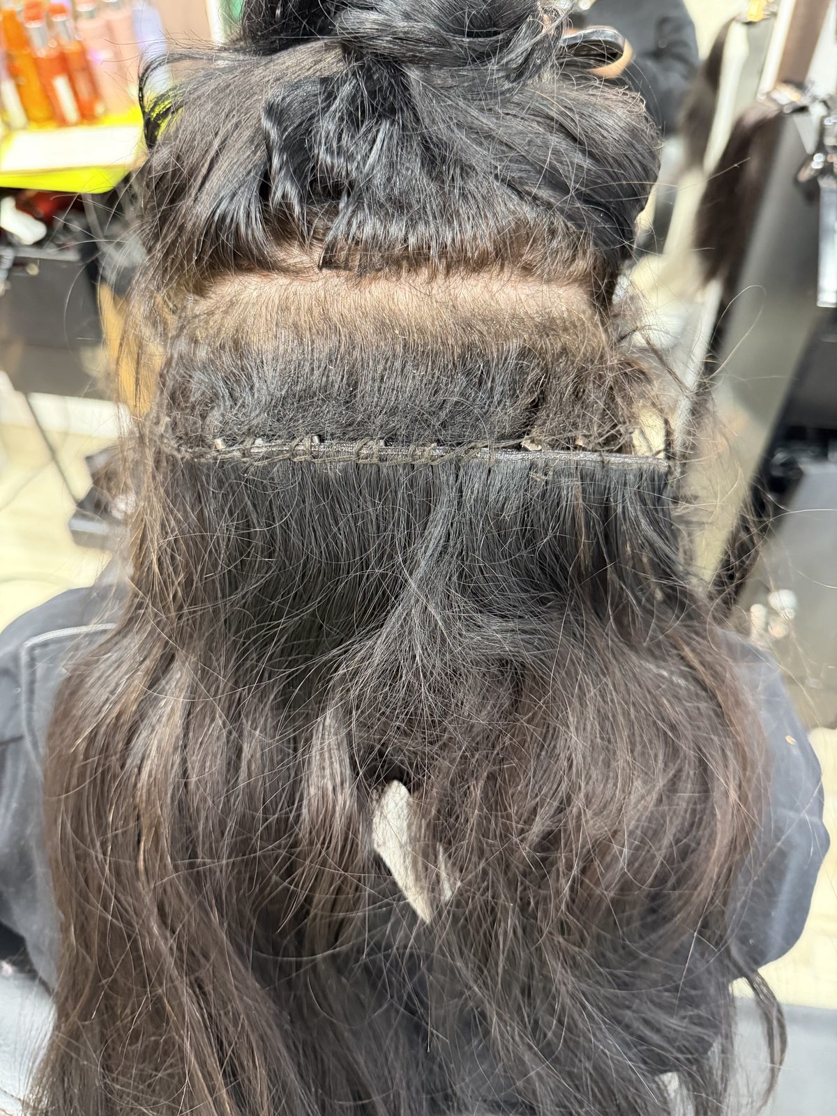 Real hair extension weft installation at Chateau D'Elegance