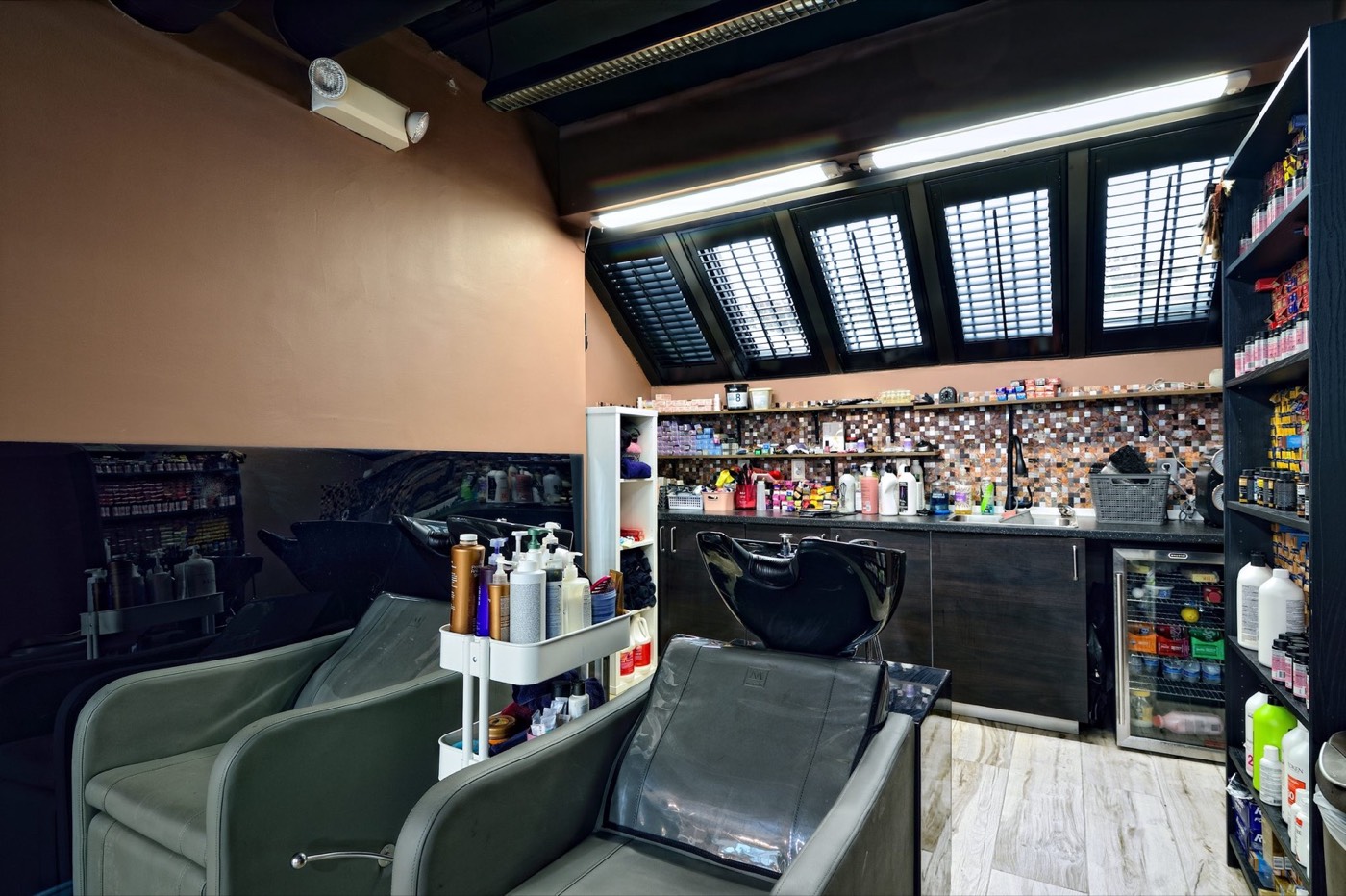 Shampoo bowls and retail wall at the salon